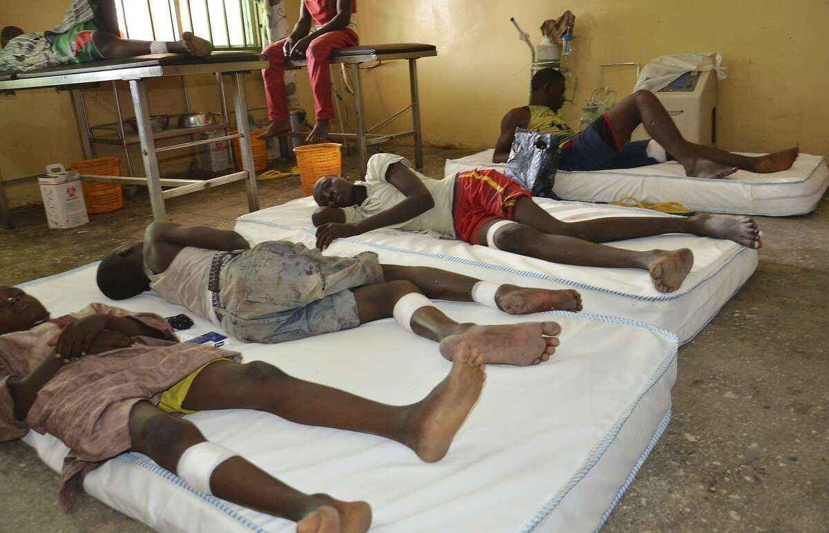 Victims receive treatment at a hospital, after an explosion in Maiduguri, Nigeria, Wednesday, June 17, 2015. A large sack of home-made bombs discovered at an abandoned Boko Haram camp exploded, killing 63 people, witnesses said Wednesday of a toll many times higher than in any recent attack in northeast Nigeria. The explosives were found by civilian self-defense fighters who carried the bag filled with metal objects to the nearby town of Monguno, said fighters including Haruna Bukar.
