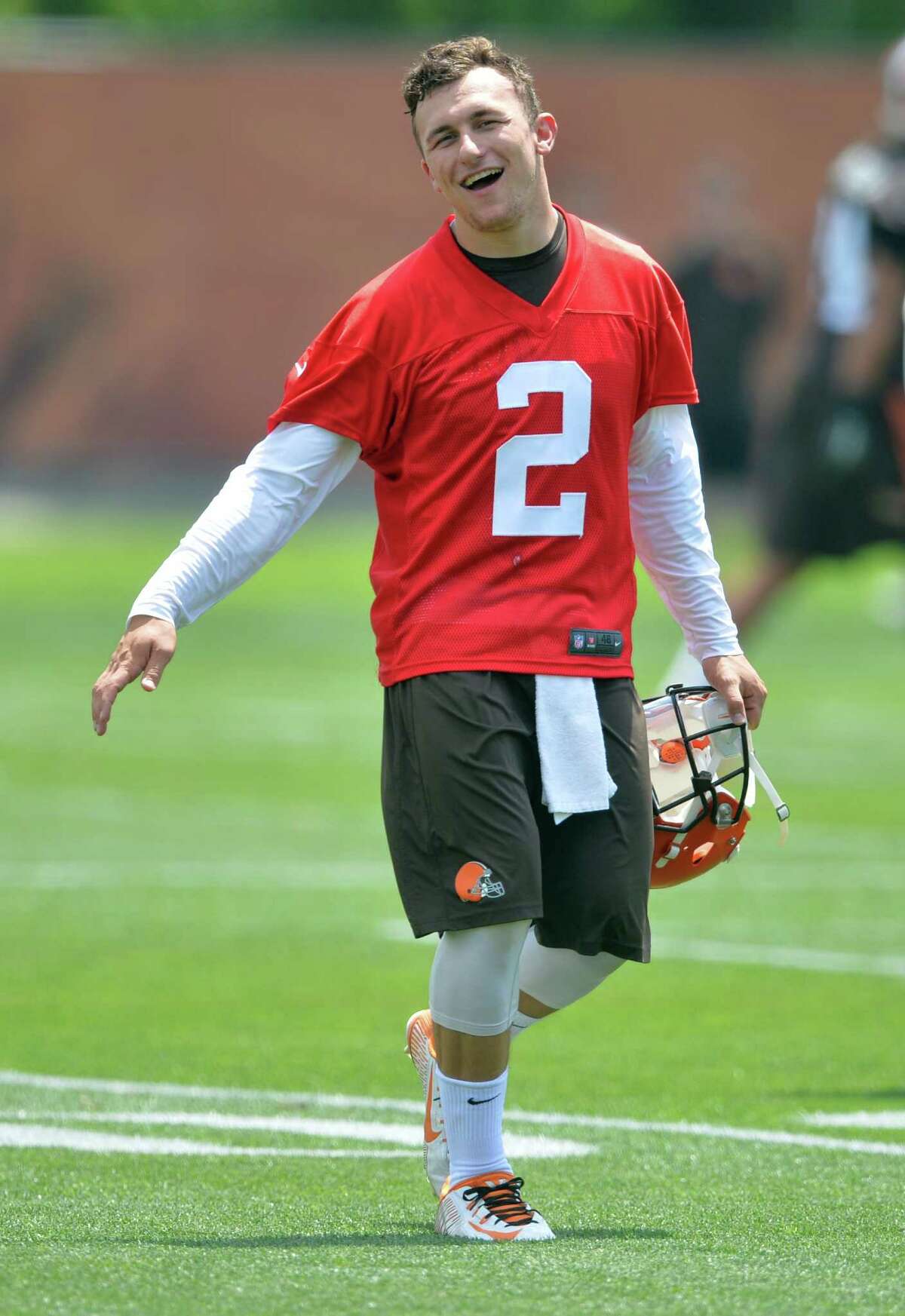 Cleveland Browns quarterback Johnny Manziel laughs as he comes off the field during minicamp in Berea, Ohio, Tuesday, June 16, 2015.