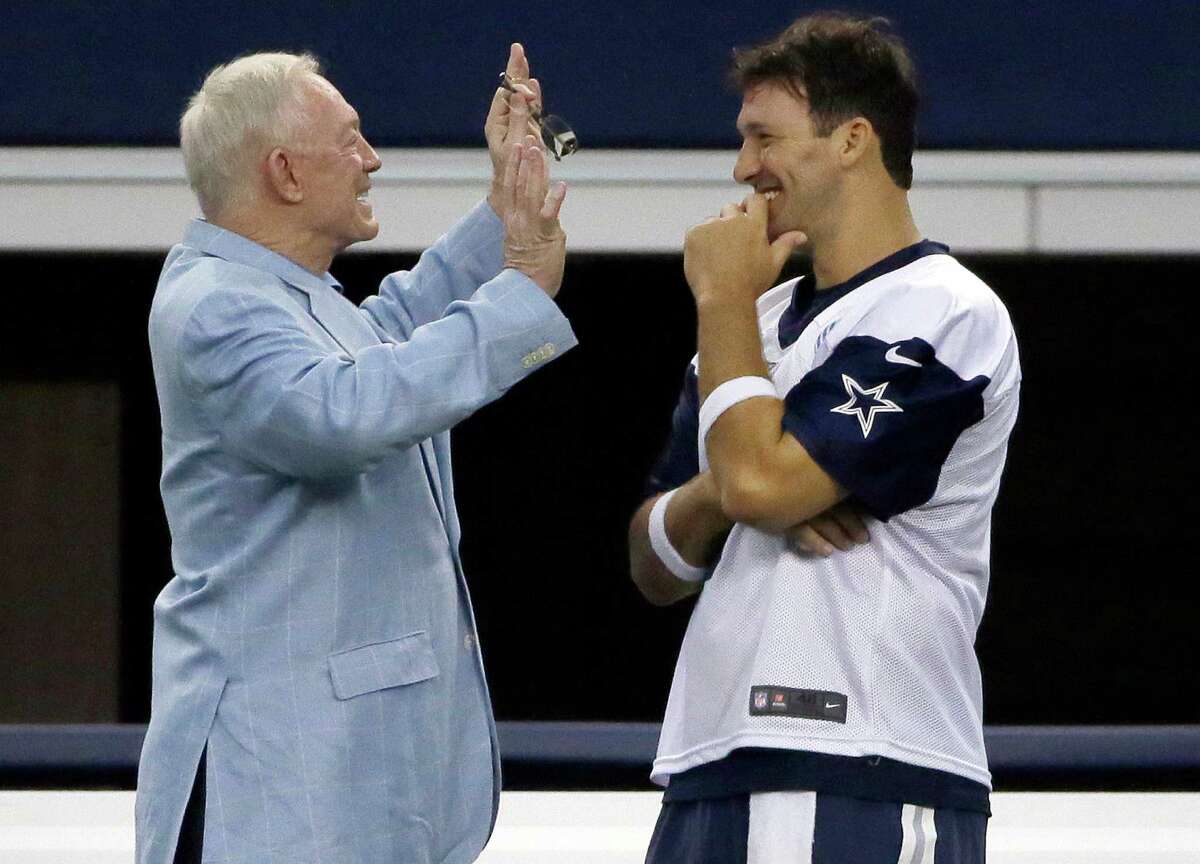 Dallas Cowboys quarterback Tony Romo, right, listens to Cowboys owner Jerry Jones as they chat on the sideline during a minicamp at the team’s stadium in Arlington on June 17, 2015.