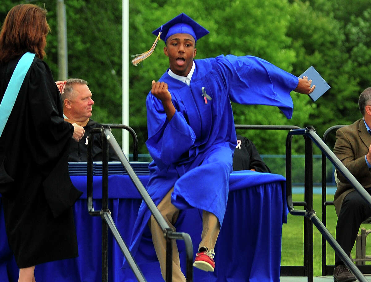 Graduate Tyree Coverson dances after getting his diploma, during Seymour High School's 128th Annual Commencement in Seymour, Conn., on Wednesday June 17, 2015.