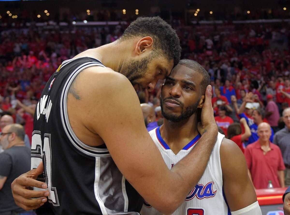 San Antonio Spurs forward Tim Duncan, left, hugs Los Angeles Clippers guard Chris Paul after the Clippers won Game 7 in a first-round NBA basketball playoff series, Saturday, May 2, 2015, in Los Angeles. The Clippers won 111-109. (AP Photo/Mark J. Terrill)