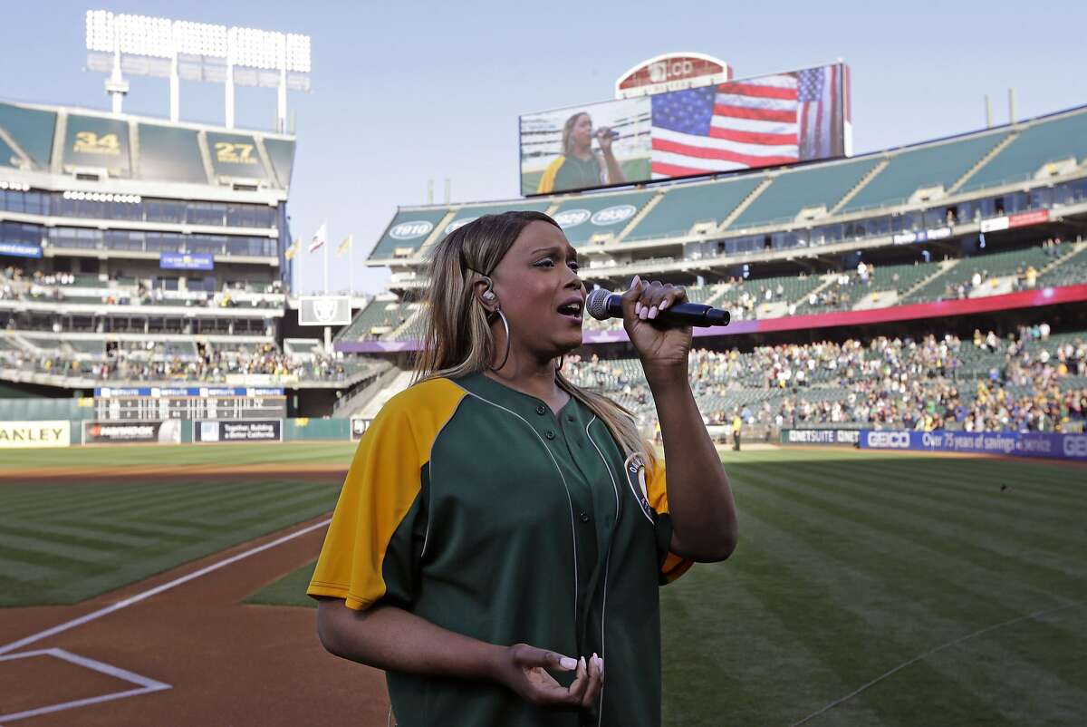 Breanna Sinclaire sings the national anthem prior to the baseball game between the San Diego Padres and the Oakland Athletics Wednesday, June 17, 2015, in Oakland, Calif. (AP Photo/Ben Margot)