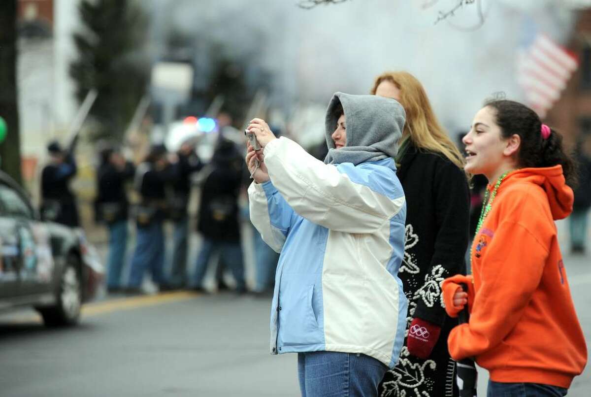 Kathleen Cardamone, with camera, and Christine Cardamone, right, watch the St. Patrick's Day Parade as it winds onto West St. Danbury Sunday afternoon, March 14, 2010.