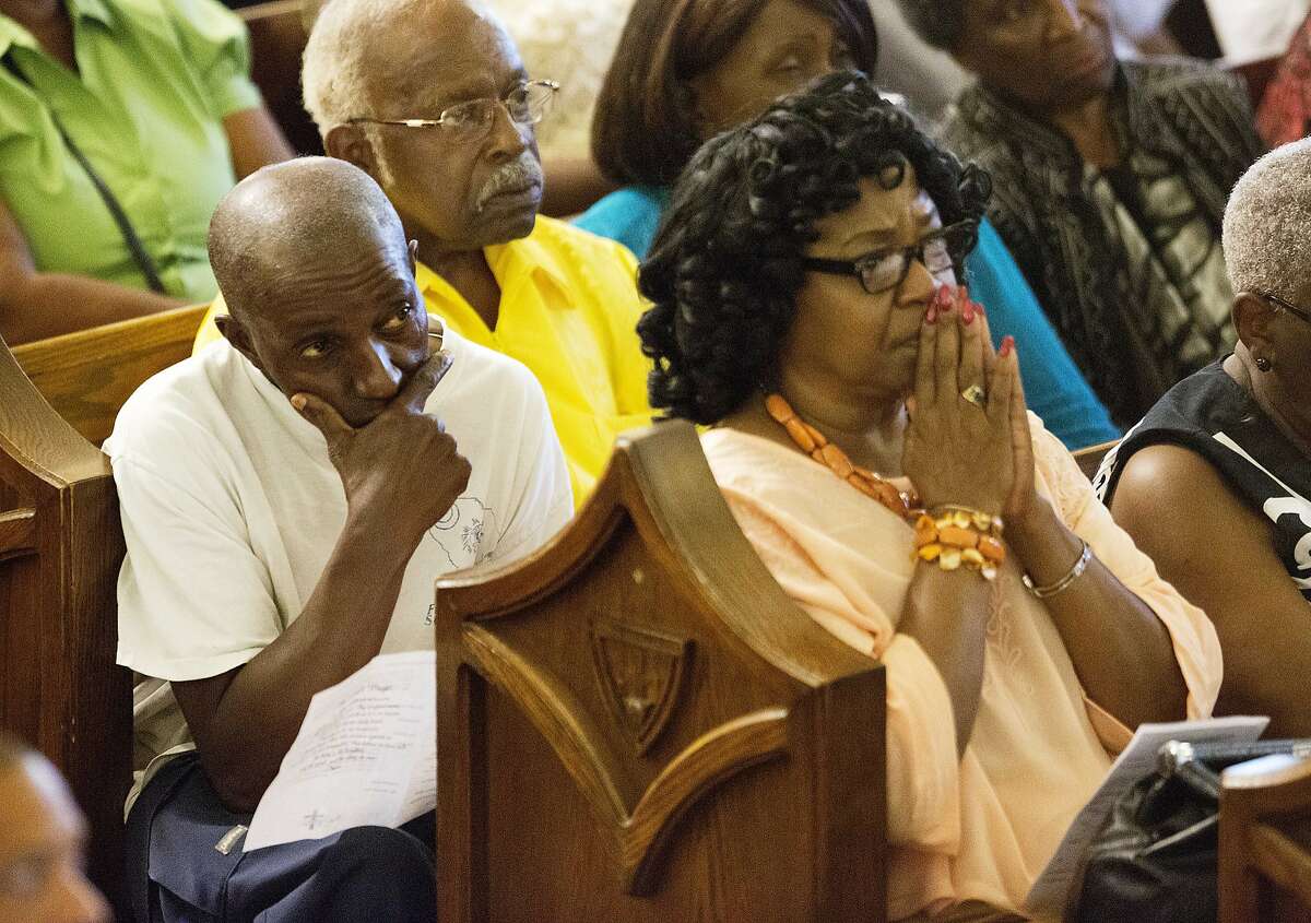 Parishioners listen during a memorial service at Morris Brown AME Church for the nine people killed Wednesday during a prayer meeting inside a historic black church in Charleston, S.C., Thursday, June 18, 2015. (AP Photo/David Goldman)