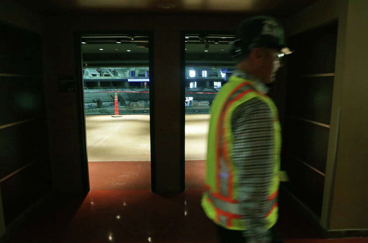 A worker passes the entrance to two luxury suites at the AT&T Center during a tour on Thursday June 18, 2015. The Spurs home is going through a complete remodel.
