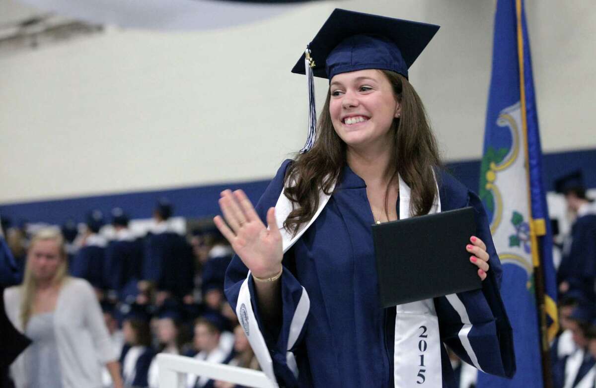 Staples High School graduate Emily Philips waves after receiving her diploma during commencement exercises in Westport, Conn. on Thursday, June 18, 2015.