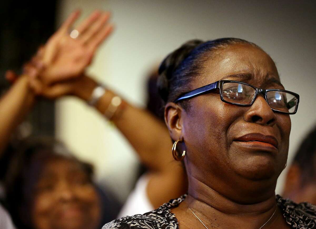 Rev. Jeannie Smalls cries during a prayer vigil held at Morris Brown AME Church for the victims of Wednesday's shooting at Emanuel AME Church on Thursday, June 18, 2015 in Charleston, S.C. Dylann Storm Roof, 21, was arrested Thursday in the slayings of several people, including the pastor at a prayer meeting inside the historic black church.(Grace Beahm/The Post And Courier via AP, Pool)