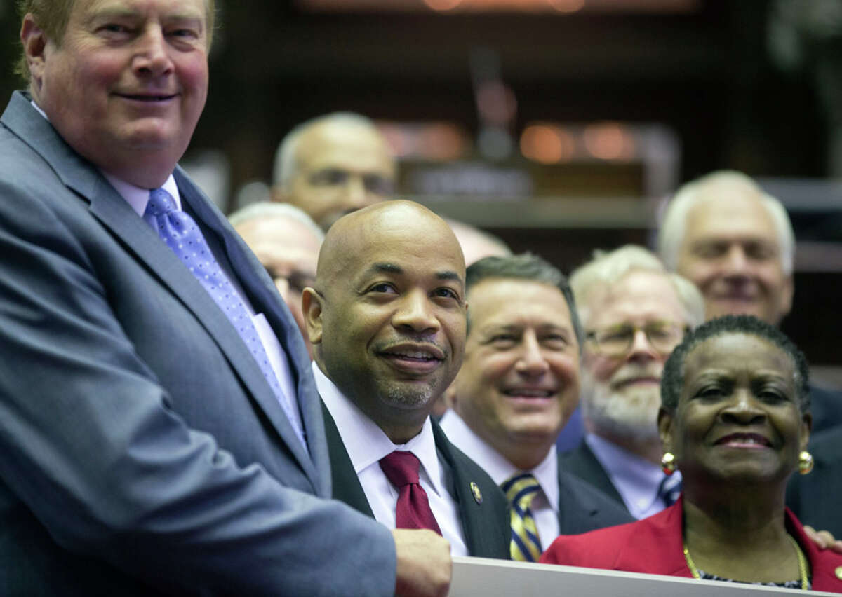 Assembly Speaker Carl Heastie, D-Bronx, second from left, poses for a photo with members who have served 10 years, in the Assembly Chamber at the Capitol on Thursday, June 18, 2015, in Albany, N.Y. Tired lawmakers have returned to the Capitol for another day as leaders continue to search for a deal to end a showdown over New York City's lapsed rent regulations. (AP Photo/Mike Groll) ORG XMIT: NYMG102