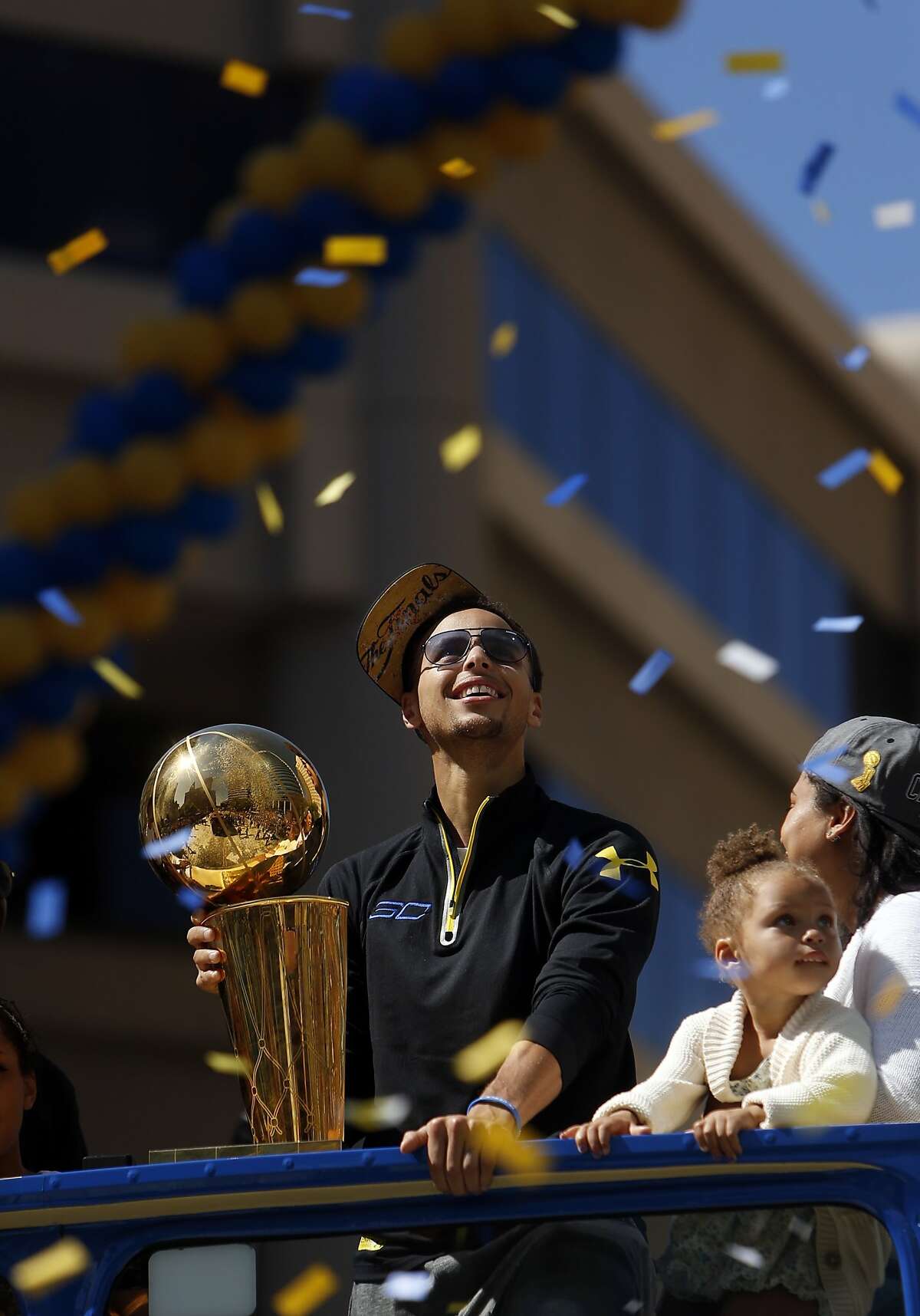 Stephen Curry and his daughter Riley soak in the atmosphere during Golden State Warriors' victory parade down Broadway in Oakland, Calif., on Friday, June 19, 2015.