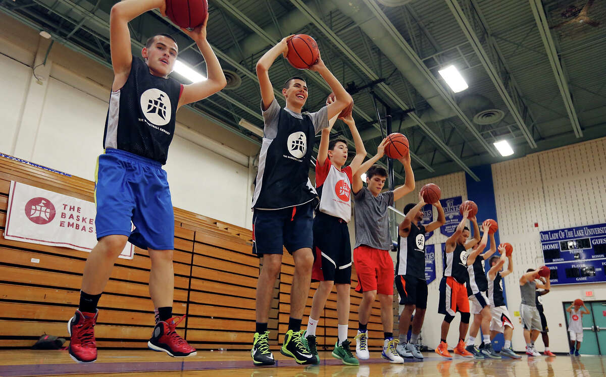 Basketball players run drills during The Basketball Embassy's inaugural Assembly 2015 camp Thursday June 18, 2015 at Our Lady of the Lake University's Mabee Gym.