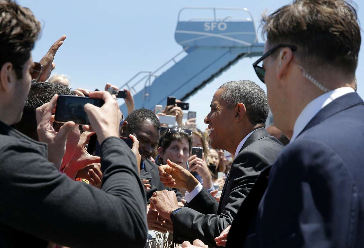 President Barack Obama greets people at San Francisco Airport in San Francisco, California, on Friday, June 19, 2015. He is in the Bay Area Friday to speak at a mayor's conference and two fundraisers.