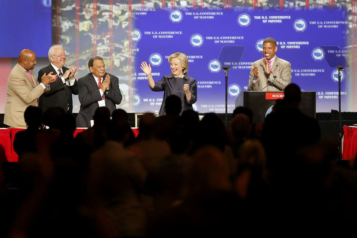 Democratic presidential candidate Hillary Clinton waves to the crowd before her speech at the U.S. Conference of Mayors in San Francisco, California, on Saturday, June 20, 2015. Clinton spoke about the shooting in Charleston and the continued existence of racism in the United States.