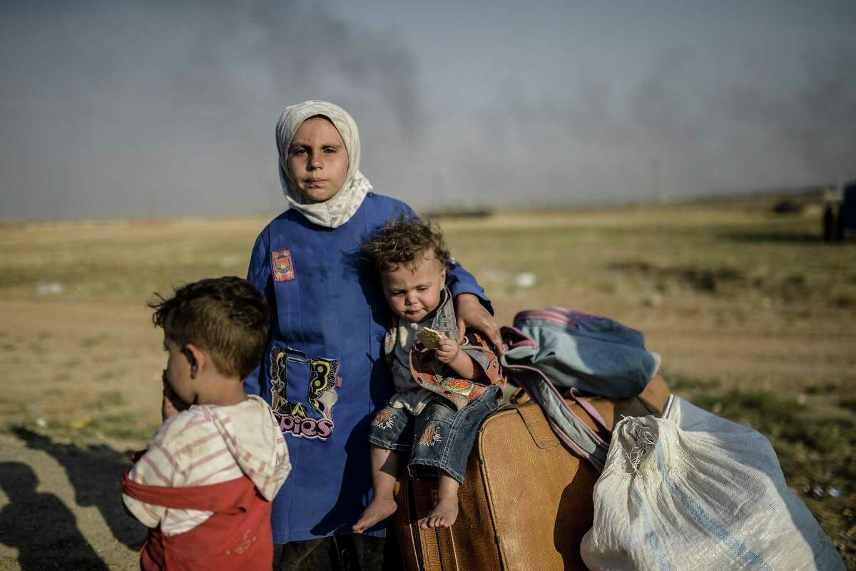 Syrian children wait to enter ﻿Turkey. According to the United Nations, the conflict has left 13.5 million people, including 6 million children, in need of protection and aid.