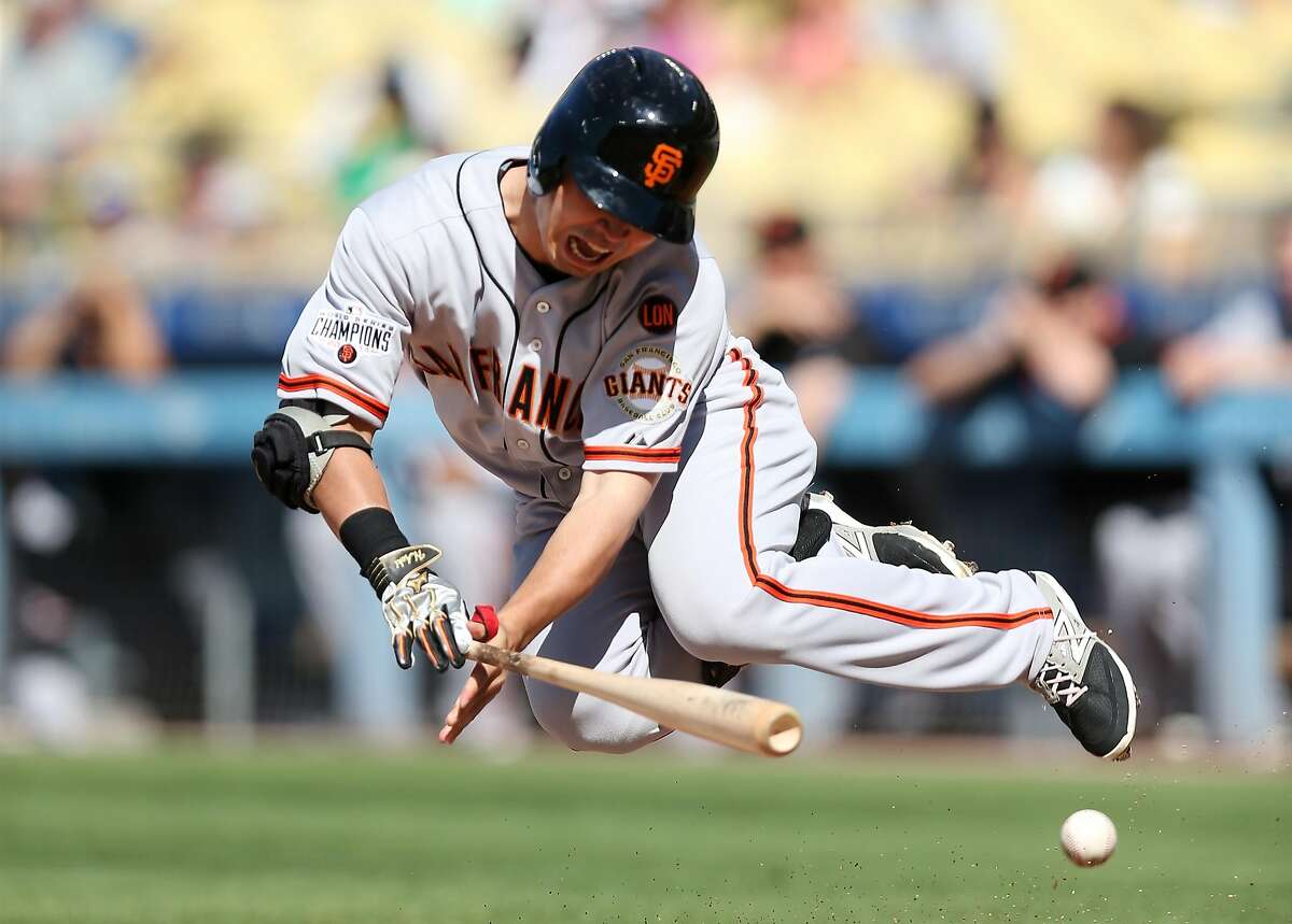 LOS ANGELES, CA - JUNE 20: Nori Aoki #23 of the San Francisco Giants goes down after being hit by a pitch in the anke in the first inning against the Los Angeles Dodgers at Dodger Stadium on June 20, 2015 in Los Angeles, California. (Photo by Stephen Dunn/Getty Images)