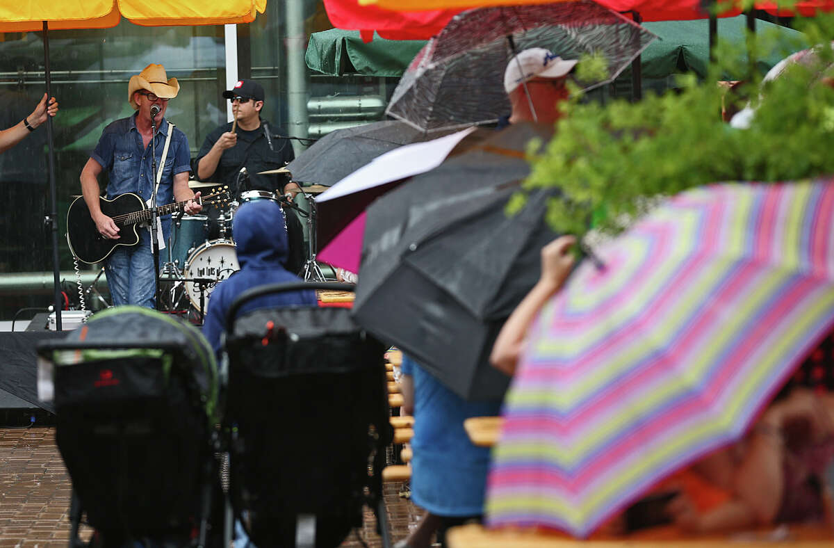 Under a pouring rain, Two Tons of Steel frontman Kevin Geil entertains the large crowd gathered for the Alamo Beer Company and Kiolbassa Sausage Fatherfest, supporting Pints for Prostates, at the brewery, Sunday, June 21, 2015.