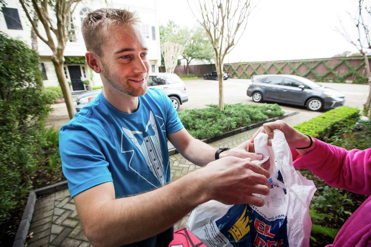 Sean Lamont, operations manager of Favor, makes a delivery on Saturday, Feb. 21, 2015, in Houston. Favor is an app designed for customers to request a delivery of almost anything. ( Brett Coomer / Houston Chronicle ) MANDATORY CREDIT-PHOTOGRAPHER Contact: Brett Coomer photoeditor@chron.com Original File Name: _A3U3554.CR2