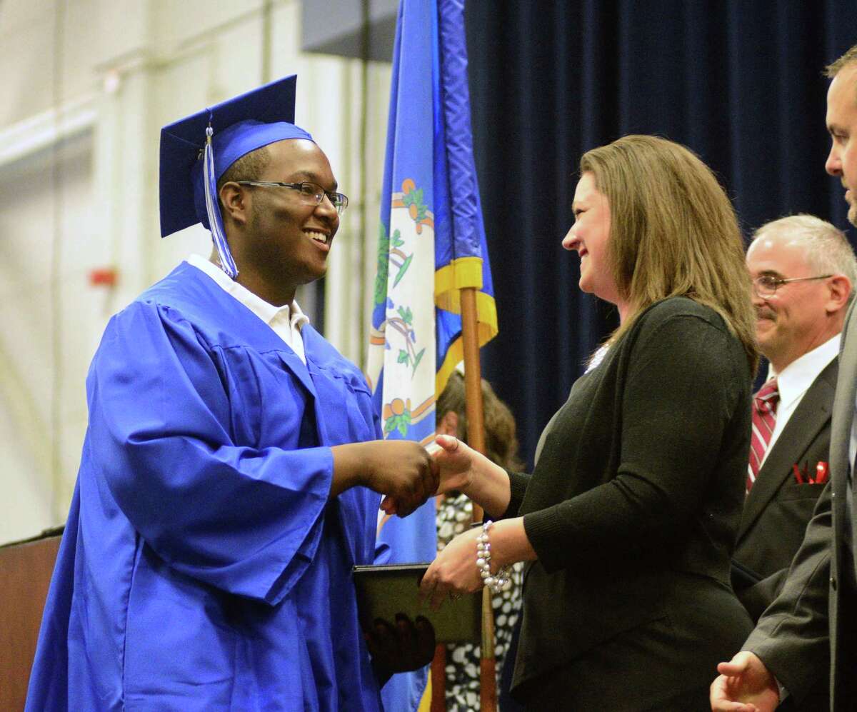 Laurence Callands receives his diploma during Henry Abbott Technical High Schools Commencement Ceremony at Western Connecticut State University's O'Neill Center on Monday, June 22, 2015.