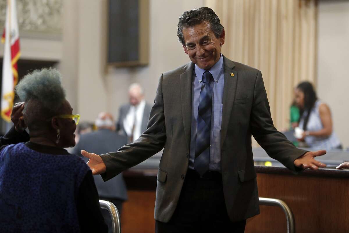 Councilmember Noel Gallo talks to an audience member before a special meeting of the Oakland City Council to hear comments and discuss 2015-2017 budget in Oakland, Calif., on Monday, June 22, 2015.