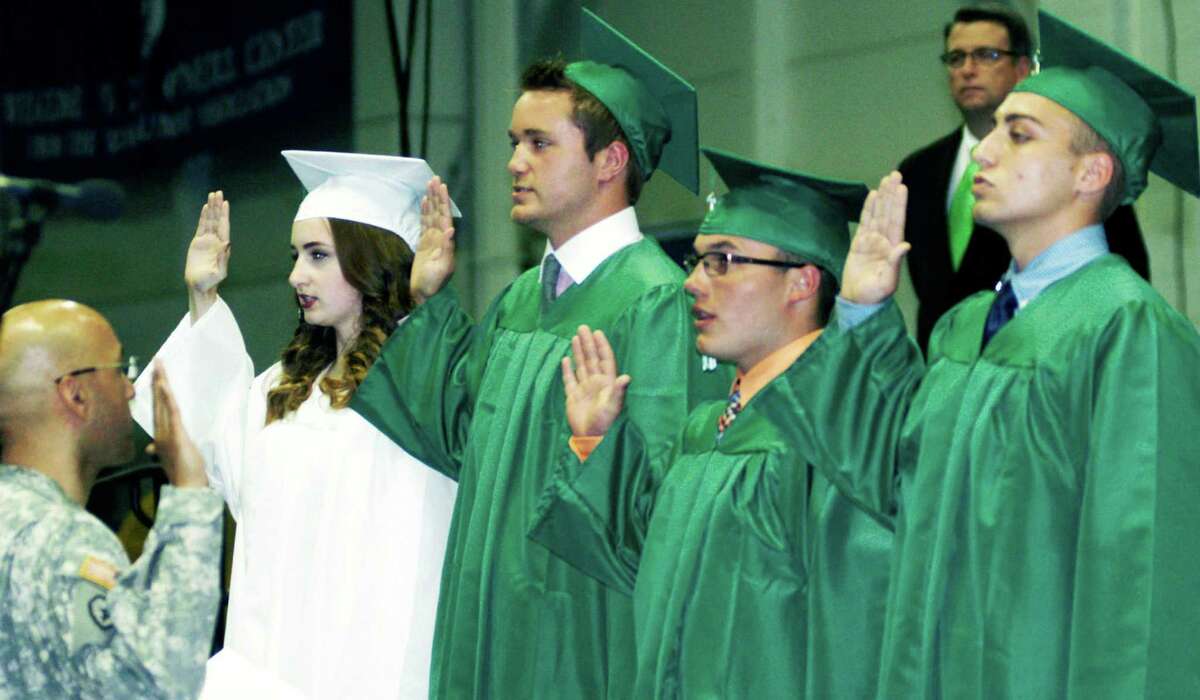 Class of 2015 members, from left to right, Eliza Alemany, Wade Elsesser, Mike Eng and Zachary Scoular, are sworn into United States military service moments before the New Milford High School commencment ceremony at the O'Neill Center, on the campus of Western Connecticut State University in Danbury, June 20, 2015.