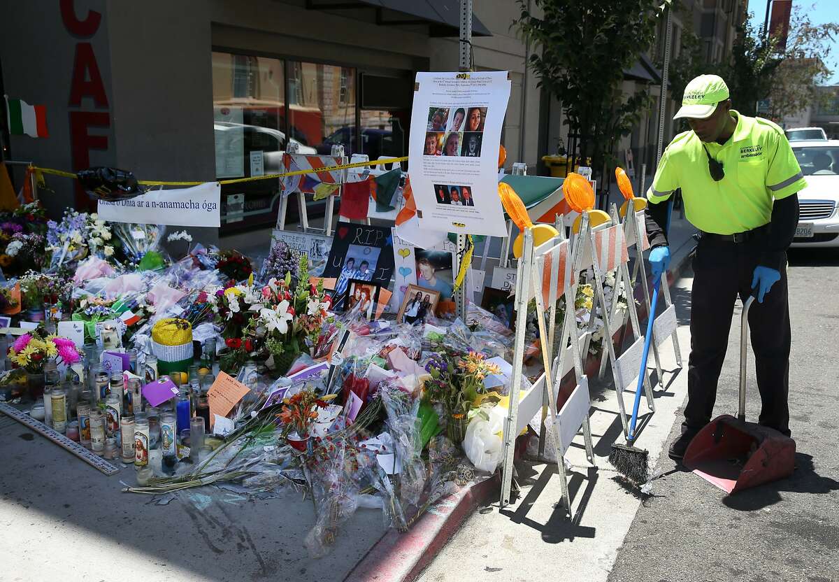 Maalik Redditt sweeps the area around a memorial erected for the victims of last week's fatal balcony collapse in Berkeley, Calif. on Tuesday, June 23, 2015. Six people died after an apartment balcony they were on collapsed while the group was celebrating a friend's birthday last week.