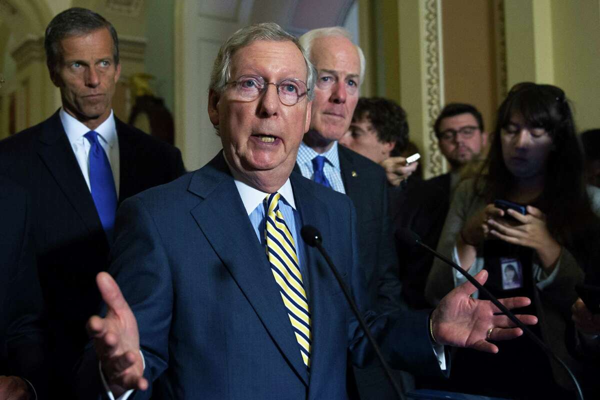Senate Majority Leader Mitch McConnell, R-Ky., speaks with reporters as Sen. John Thune, R-S.D., left and Senate Majority Whip John Cornyn, R-Tx., right, listen, after a policy luncheon at the U.S. Capitol in Washington, Tuesday, June 23, 2015. (AP Photo/Cliff Owen)