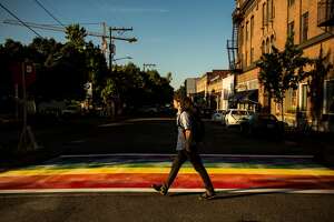 Passerby navigate the newly-installed, rainbow-colored crosswalks in various locations around Capitol Hill, photographed Tuesday, June 23, 2015, at the intersection of 10th and Pike Street in Seattle, Washington.  (Jordan Stead, seattlepi.com)
