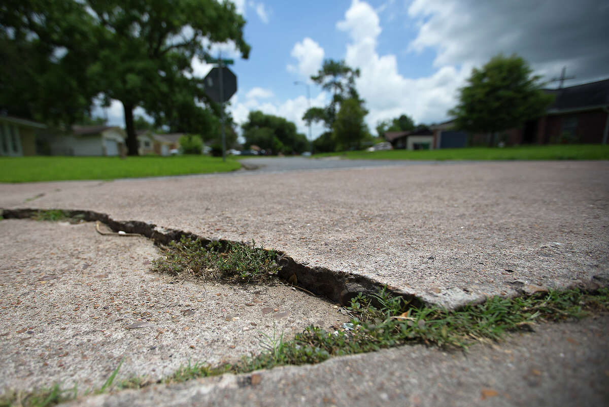 Uneven pavement is seen in the middle of Jutland Road, Tuesday, June 23, 2015, in Houston. As mayoral hopefuls navigate the political implications of the ReBuild Houston lawsuit, residents are left to consider the practical fallout; if drainage fee collection is halted, some roads and drainage projects scheduled late next fiscal year would almost certainly be scratched.