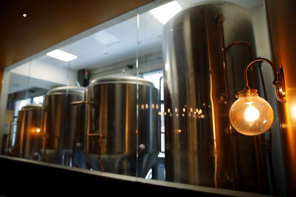 Brewing equipment sits in a room visible through a large window in Dirty Water in San Francisco, California, on Tuesday, June 23, 2015. The bar plans on brewing beer on site.