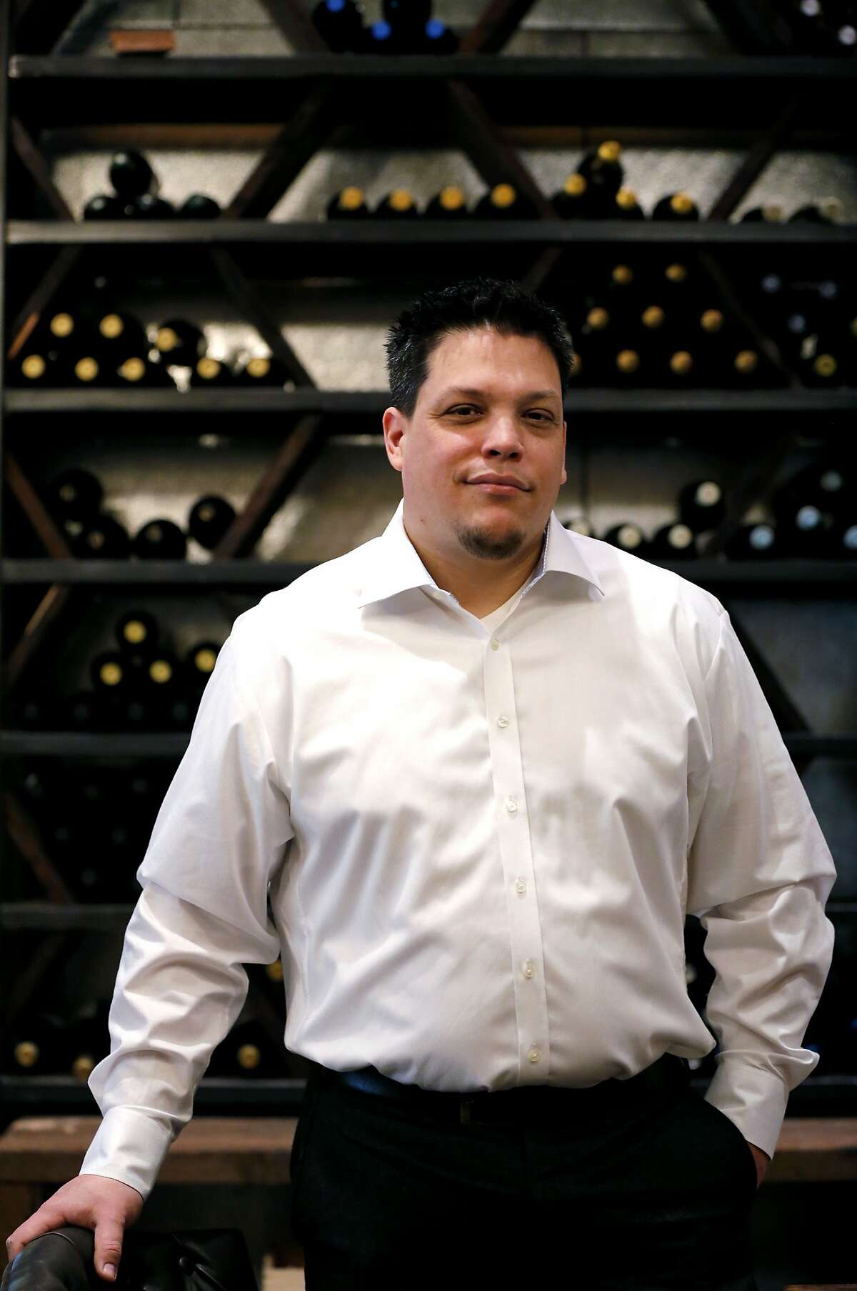 Kristian Cosentino, founder of Dirty Water and self-described "beverage geek," stands in front of a tall wine rack in his restaurant in San Francisco, California, on Tuesday, June 23, 2015. A