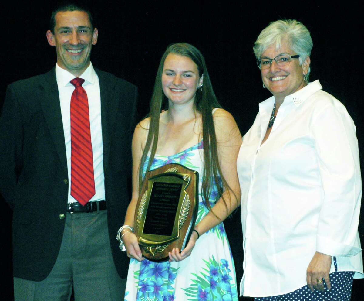 Kelsey Johnson poses with Spartan athletic director Matt Perachi and Shepaug principal Kim Gallo after being presented during Shepaug Valley School's annual sports awards ceremony with the prestigious Ray Marinko Award as the Berkshire League's top athlete for 2014-15 on June 5.