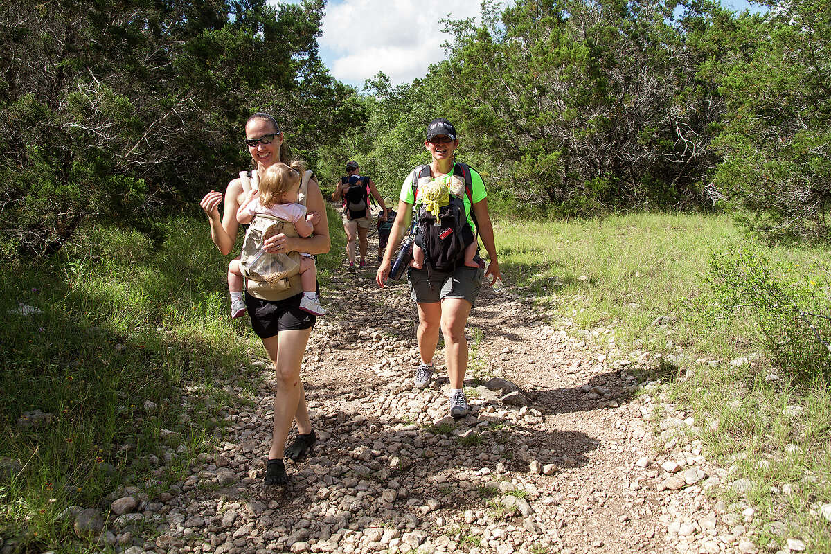 (Left to right) Jennifer Caulk and Jennifer Ward carry their children while hiking with the Hike It Baby San Antonio group, Saturday, June 6, 2015, at Government Canyon State Natural Area.