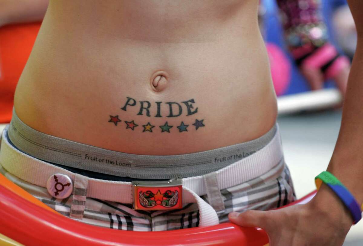 Tanner Wills, 20, shows off his tattoo before the Gay Pride Parade.Meryl. 