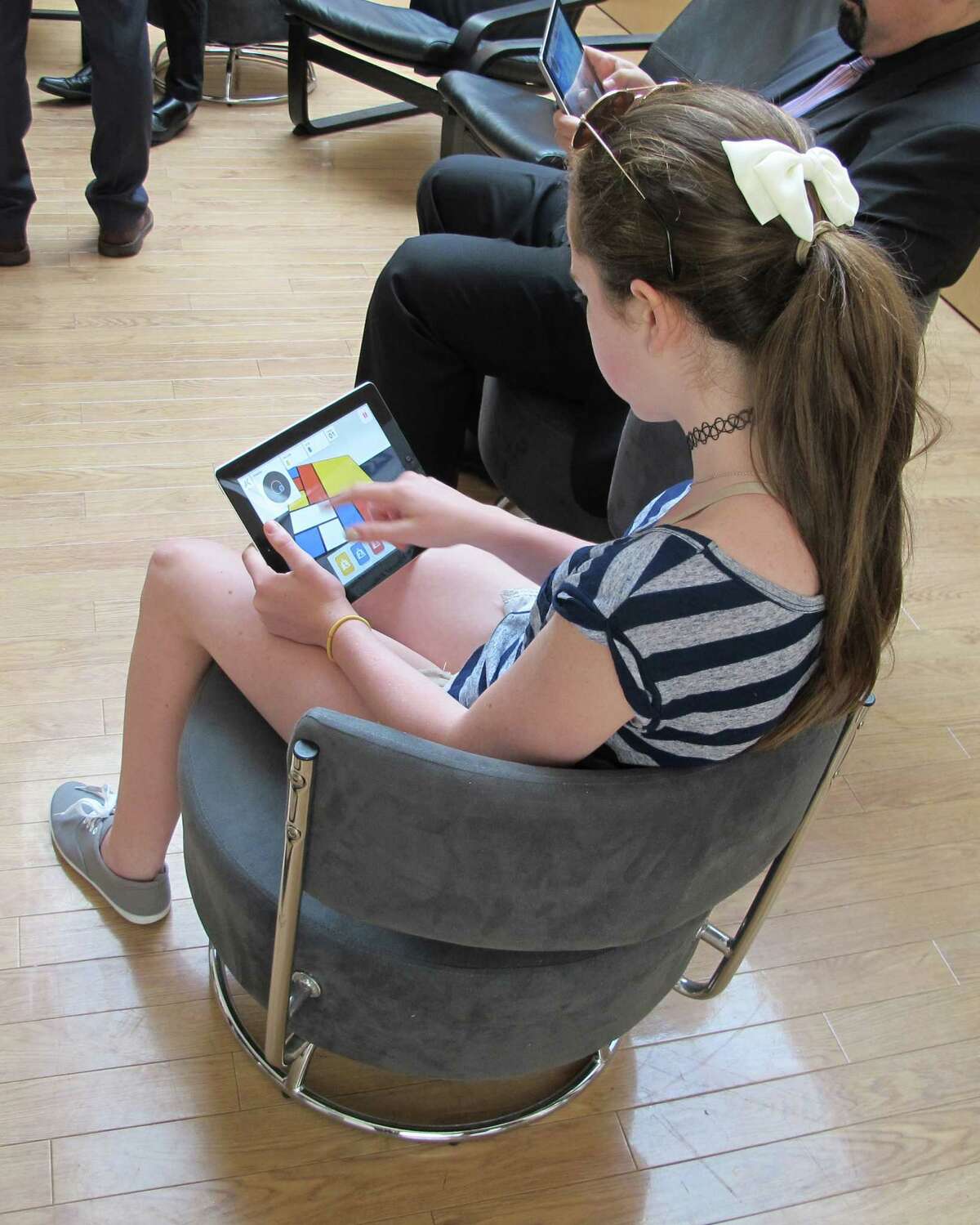 Jamie Drury, 12, plays the game "Equilibrian" at the Albright-Knox Art Gallery in Buffalo, N.Y., Thursday, June 25, 2015. The game is one of eight contained in a new app, ArtGames 2.0, that was developed by the gallery's Innovation Lab and will be available through the Apple App Store and Google Play Store beginning Saturday. (AP Photo/Carolyn Thompson) ORG XMIT: NYR103