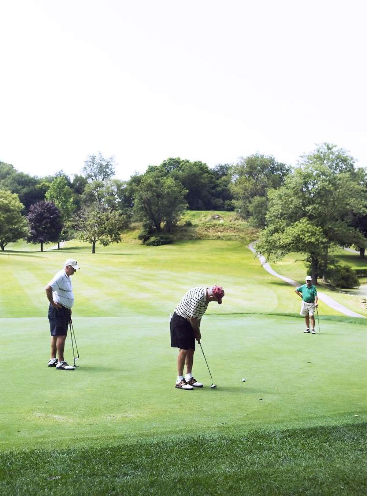 File photo of golfers as they tee off on the 13th hole at E. Gaynor Brennan Municipal Golf Course during the summer of 2009. Before taking a swing, donning those running shoes or planning a hike, it is important to make sure those muscles are ready for the motion, after a long winter’s nap.