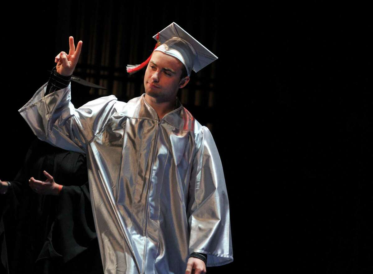 Graduate Michael Capoccia gives a peace sign to the crowd as he walks across the stage during the Niskayuna High School graduation ceremony Thursday, June 25, 2015, at Proctors Theater in Schenectady, N.Y. (Phoebe Sheehan/Special to The Times Union)