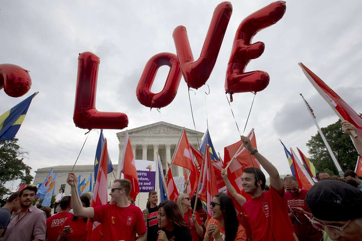 Balloons spell out the word "love" over the Supreme Court in Washington, Friday June 26, 2015, after the court declared that same-sex couples have a right to marry anywhere in the US. (AP Photo/Jacquelyn Martin)