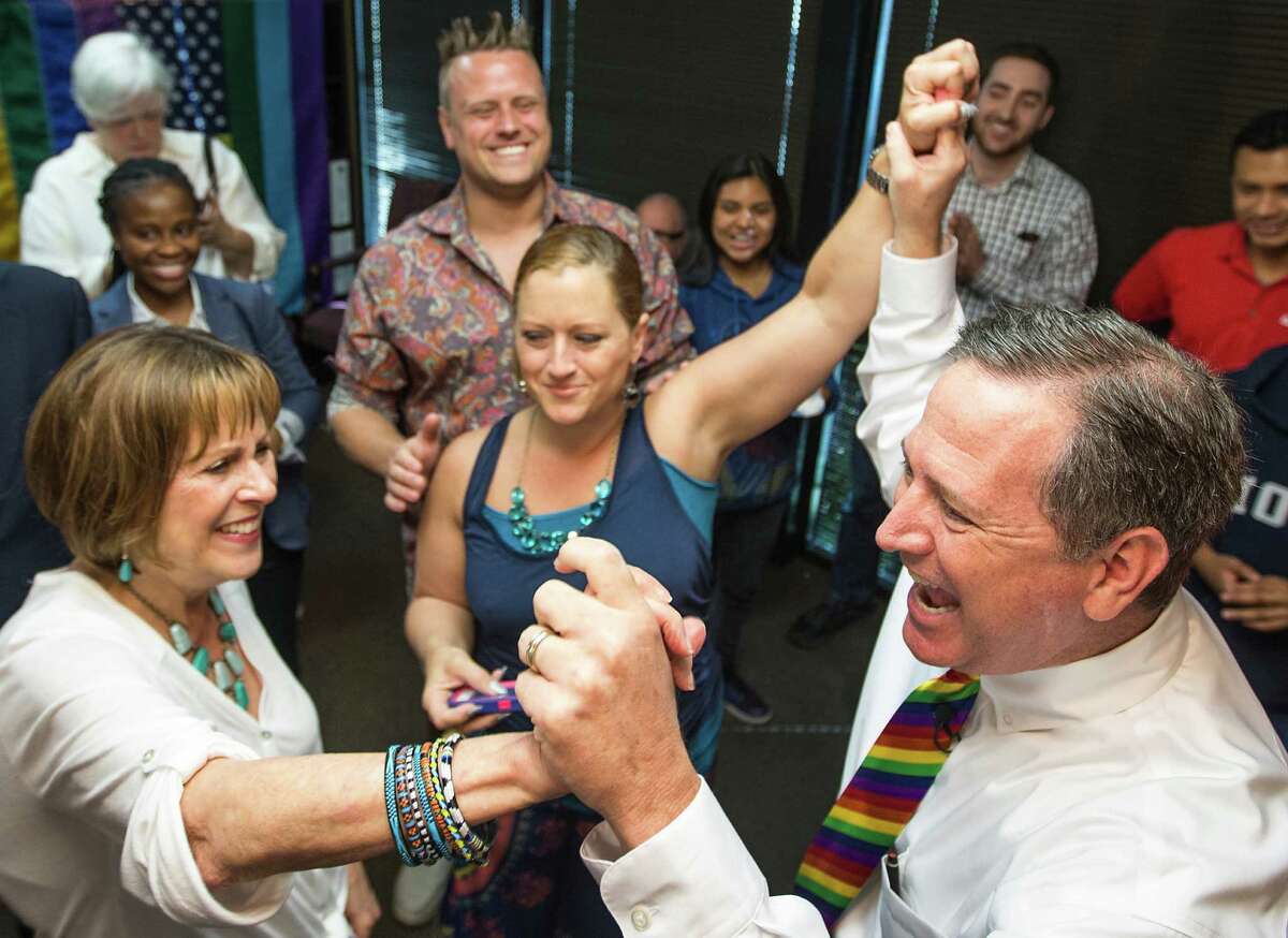 Allie Levey, left, Nikki Araguz, center, and Mitchell Katine celebrate the U.S. Supreme Court decision legalizing same-sex marriage at Katine's law office on Friday, June 26, 2015.