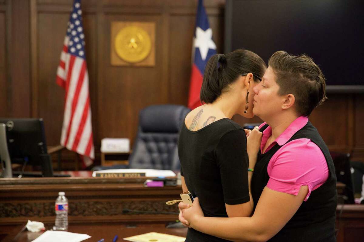 Tiana Lucas whispers in Kelly Motley's ear before getting married at the Bexar County Courthouse in San Antonio, Texas on June 26, 2015.