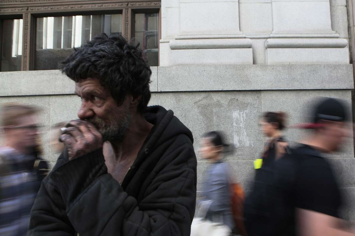 Calap Jayjenkins, 54, watches as San Franciscans in the Financial District pass by. He has been homeless for over 30 years.