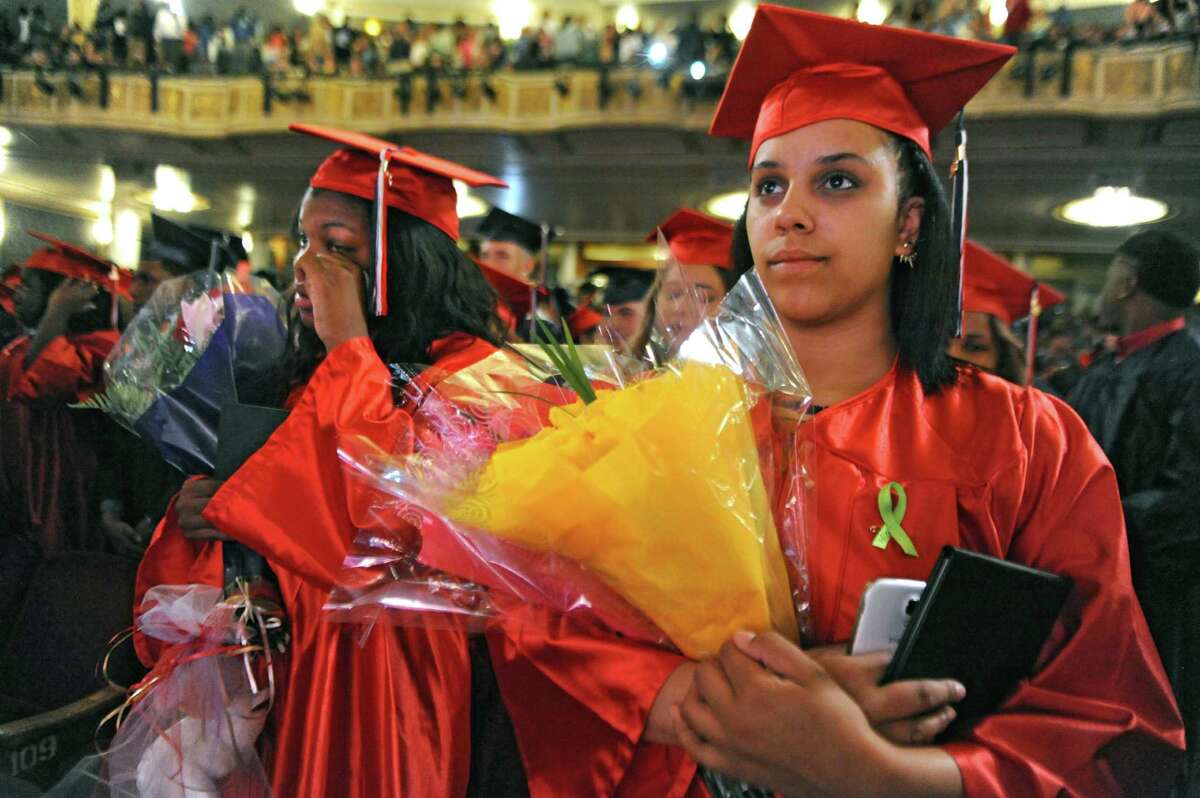 Mareyah Franco, left, wipes her tears as she stands next to her classmate Ceniya Fountain at the conclusion of their graduation ceremony for Schenectady High School at Proctors on Friday, June 26, 2015 in Schenectady, N.Y. (Lori Van Buren / Times Union)