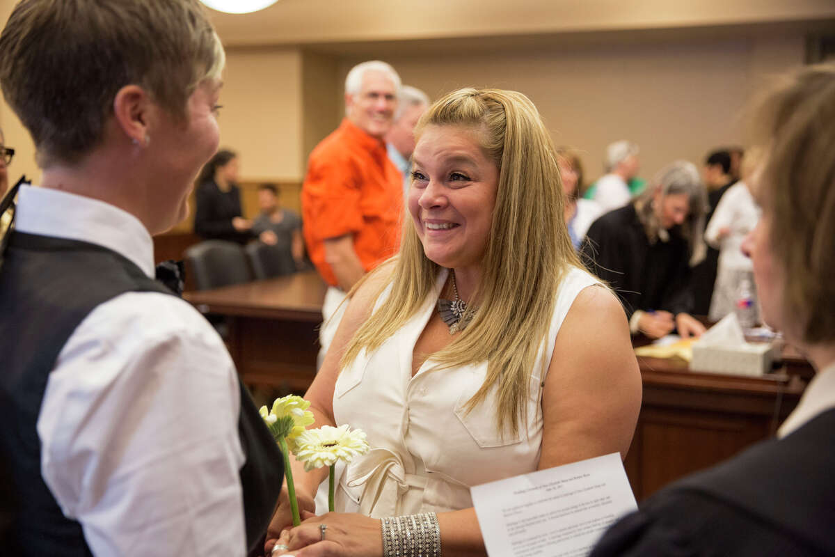 Bernice Reyes smiles at Sara Sharp during their wedding vows at the Bexar County Courthouse in San Antonio, Texas on June 26, 2015. They have been together for three and a half years.