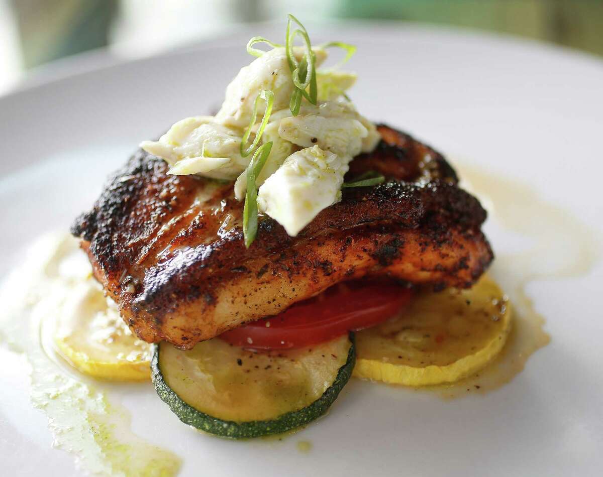The Blackened Grouper with Atkinson Farms tomatoes, zucchini and squash topped with crab meat at Harold's in the Heights on Wednesday, June 24, 2015, in Houston. ( Karen Warren / Houston Chronicle )