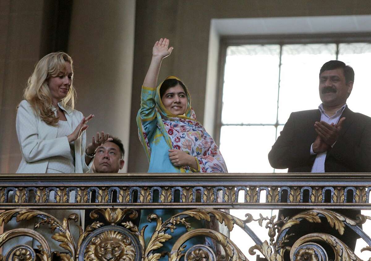 Nobel Prize laureate Malala Yousafzai waves to the crowd after being recognized on Friday, June 26, 2015, at a San Francisco City Hall celebration of the signing of the UN Charter in San Francisco 70 years prior.