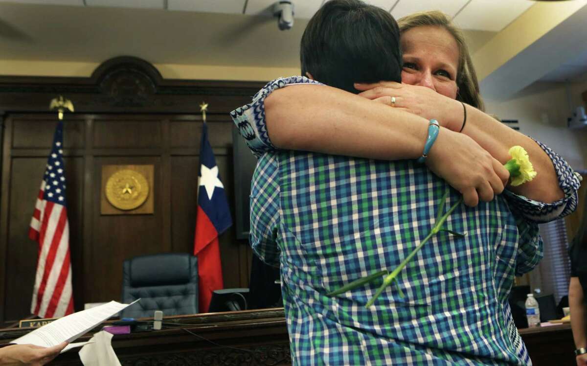 Traci Barth, right, embraces her wife Danielle Aliano as they are married in the Bexar County Courthouse by Judge Karen Pozza. Gay couples could get their marriage license at the Bexar County Courthouse after the Supreme Court voted in favor of same sex weddings, on Friday, June 26, 2015. Some of the couple were married in the Presiding Court the same day.