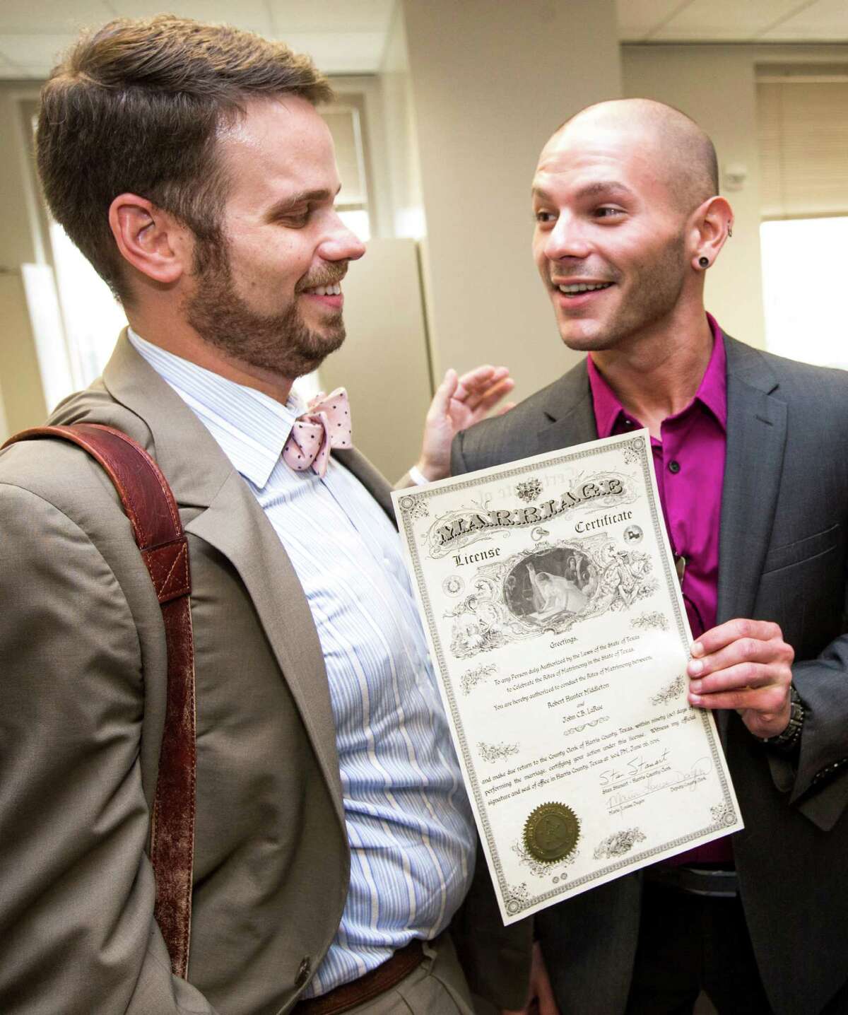 John LaRue, left, and Hunter Middleton proudly receive their marriage license ﻿on Friday.