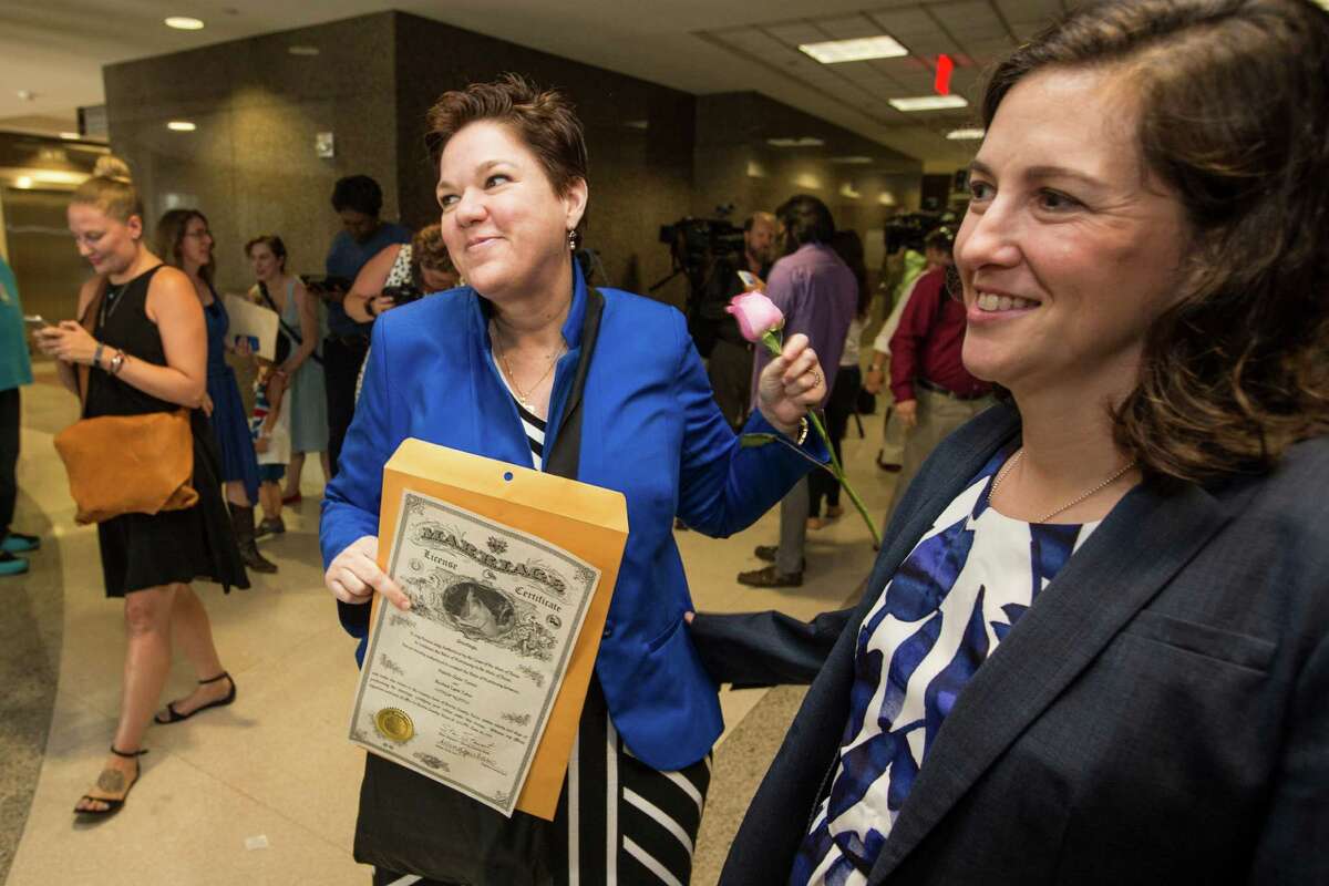 Valerie Turner, left, and Rachel Tobor celebrate the historic ruling Friday by being issued their marriage license at the Harris County Clerk's Office.