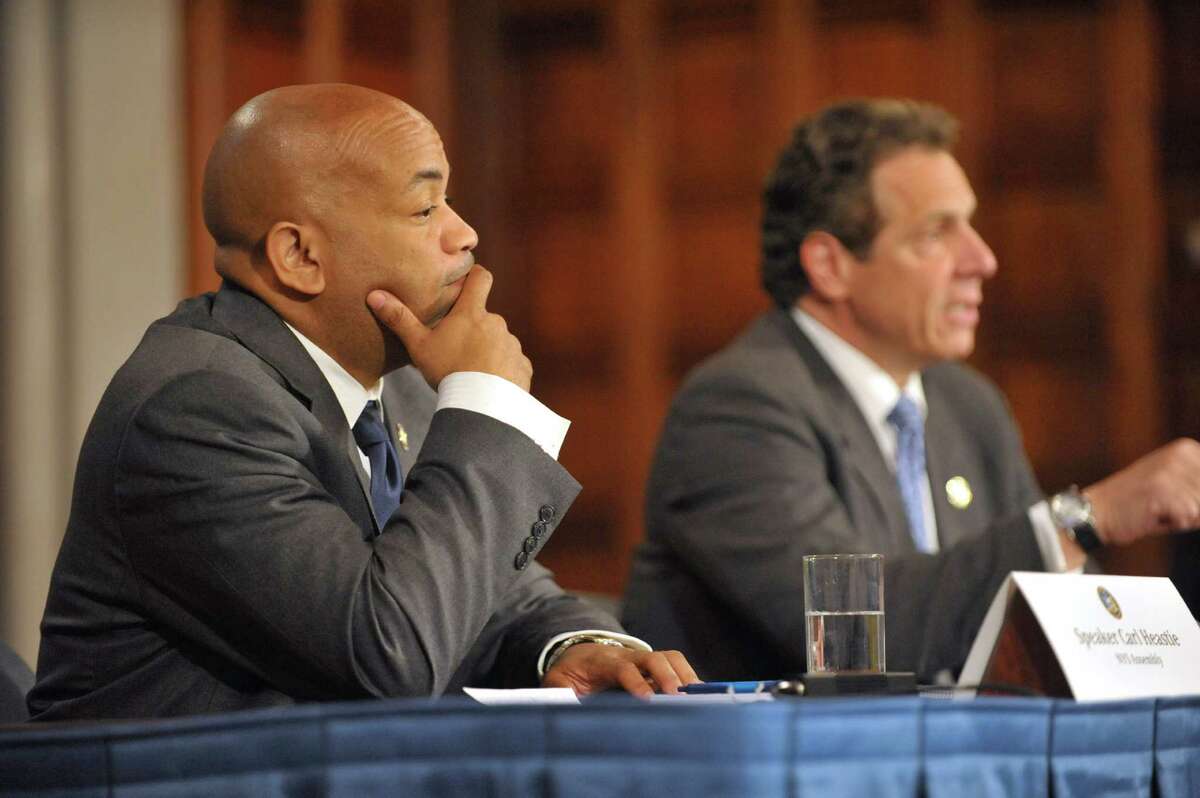 New York State Assembly Leader Carl Heastie, left, listens as Governor Andrew Cuomo, right, answers a question during a press conference at the Capitol on Tuesday, June 23, 2015, in Albany, N.Y. (Paul Buckowski / Times Union)