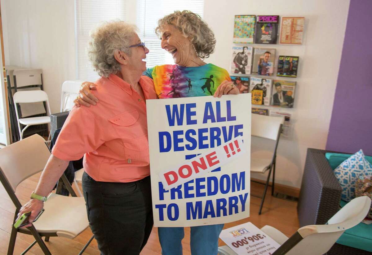 Shelly Bailes and her wife Elen Pontac of Davis wait for a press conference at the LGBT Center in Sacramento after the Supreme Court announcement on gay marriage on Friday, June 26, 2015. Same-sex couples won the right to marry nationwide Friday as a divided Supreme Court handed a crowning victory to the gay rights movement, setting off a jubilant cascade of long-delayed weddings in states where they had been forbidden. (Hector Amezcua/The Sacramento Bee via AP) MAGS OUT; LOCAL TELEVISION OUT (KCRA3, KXTV10, KOVR13, KUVS19, KMAZ31, KTXL40); MANDATORY CREDIT