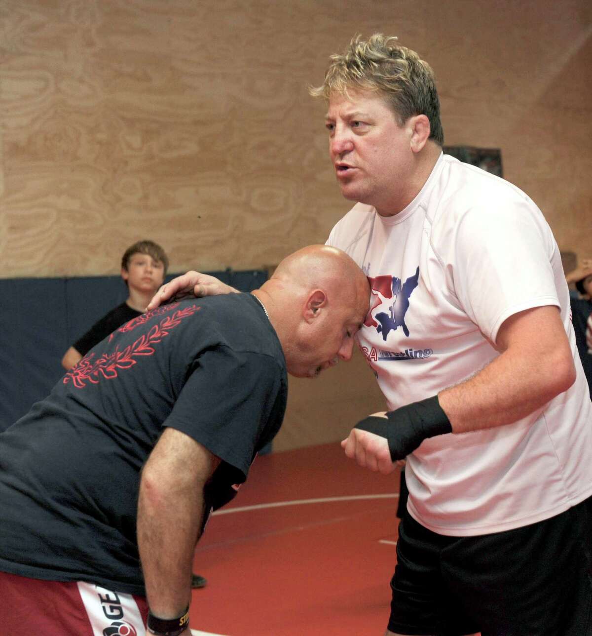 Royce Alger, right, explains a wrestling position with the assistance of John Kijek, a USA wrestling coach Tuesday.