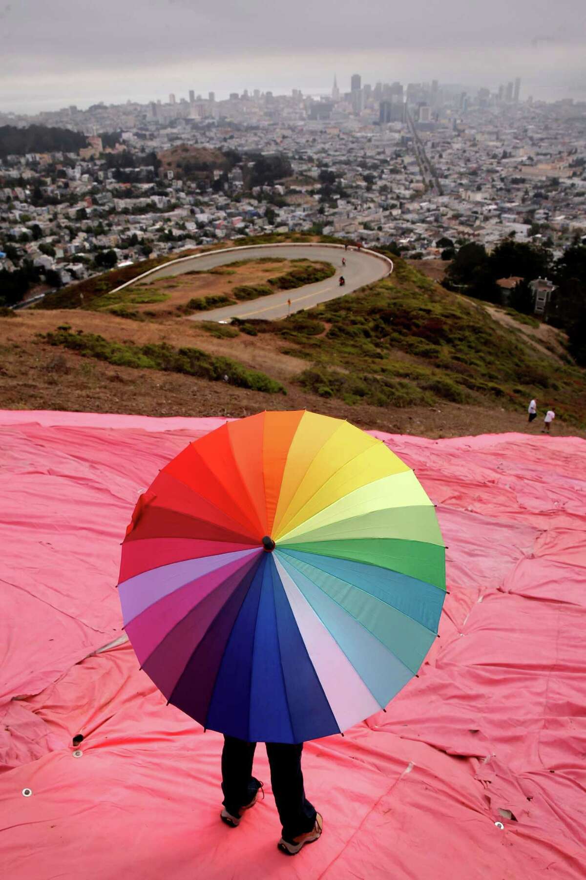 Volunteers atop Twin Peaks in San Francisco on Saturday install the pink triangle for Pride festivities fired up by the historic ruling. Story on A17